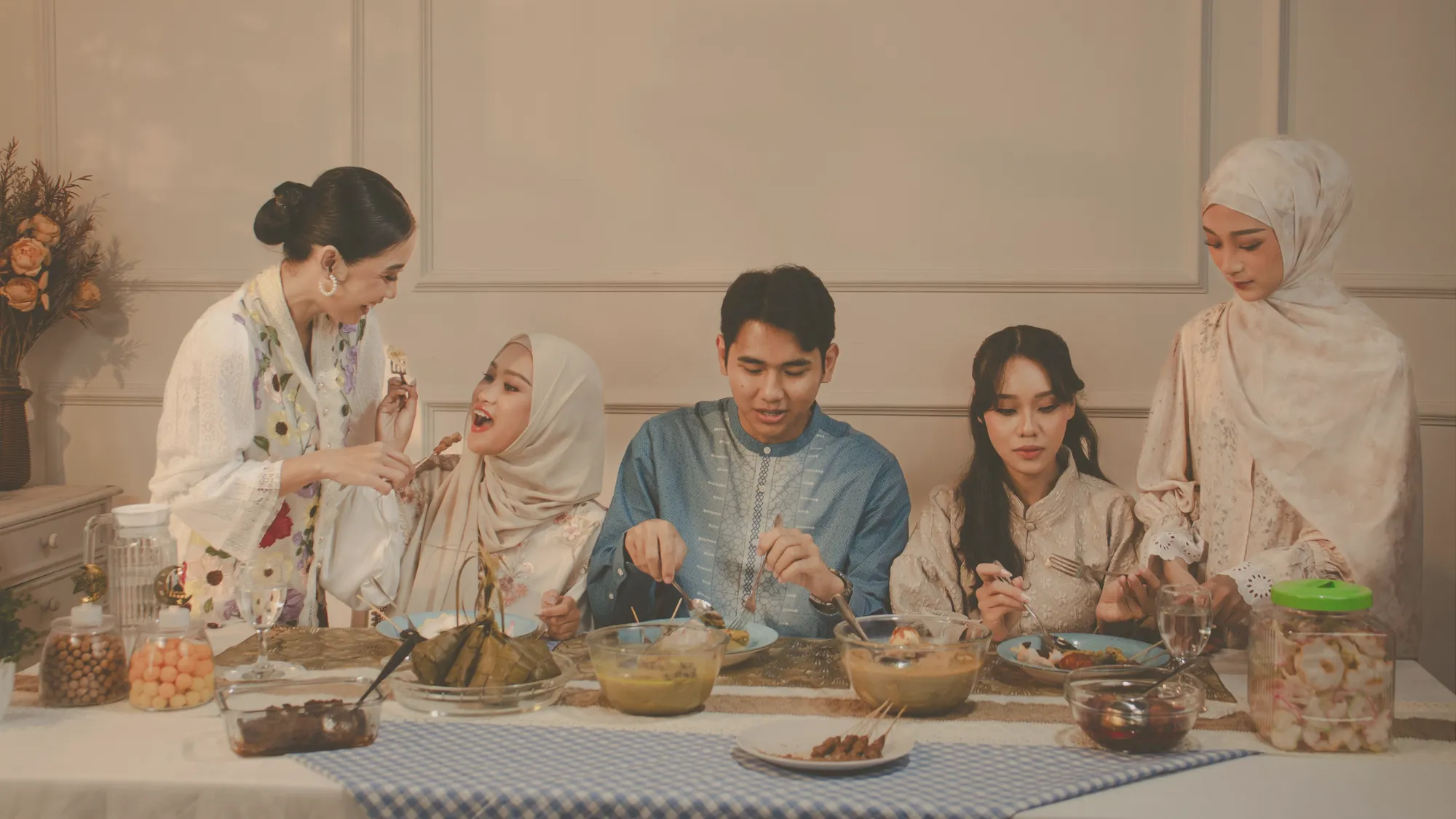 Ibu dan anak melipat handuk bersih di sofa